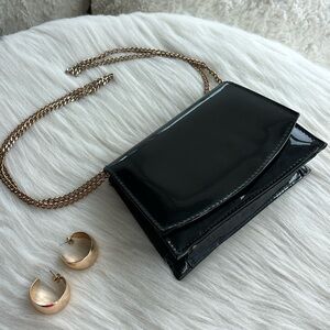 Black patent leather bag with gold hardware